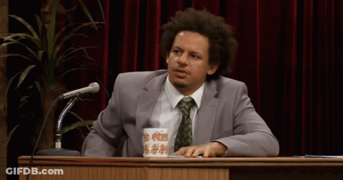 Man In Suit And Tie At Podium With Coffee GIF