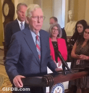 Man In Suit And Tie At Podium With US Seal GIF