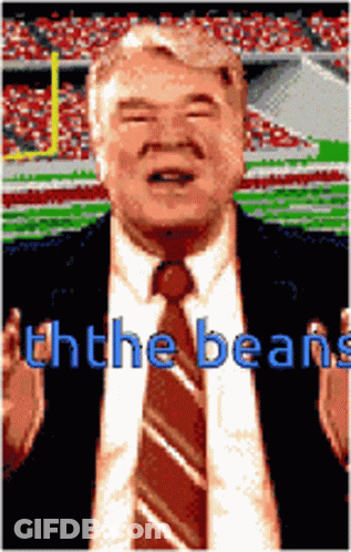 Man In Suit And Tie At Stadium Ththe Beans GIF