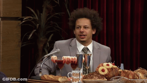 Man In Suit And Tie At Table With Food GIF