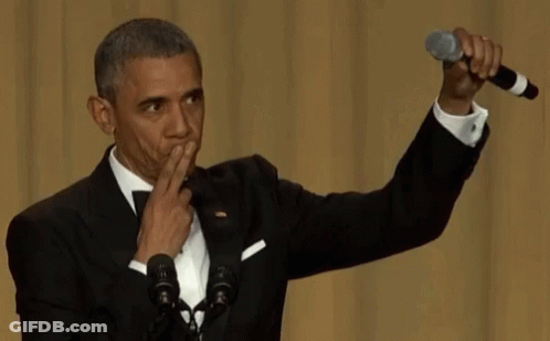 Man In Suit And Tie At Two Microphones GIF