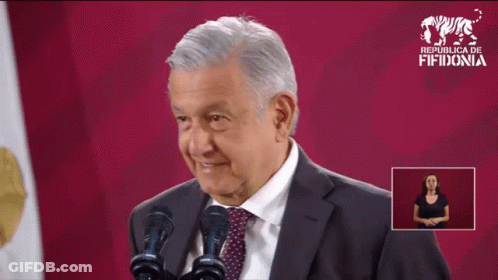 Man In Suit And Tie At Two Microphones With Sign Republica Fifidonia GIF