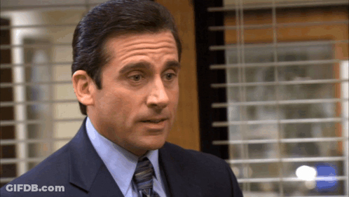 Man In Suit And Tie At Window GIF