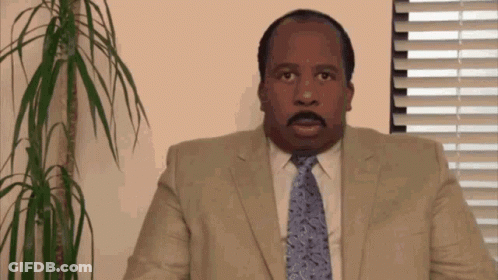 Man In Suit And Tie At Window GIF