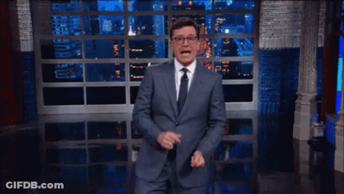 Man In Suit And Tie At Window GIF