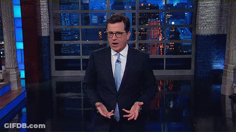 Man In Suit And Tie At Window GIF