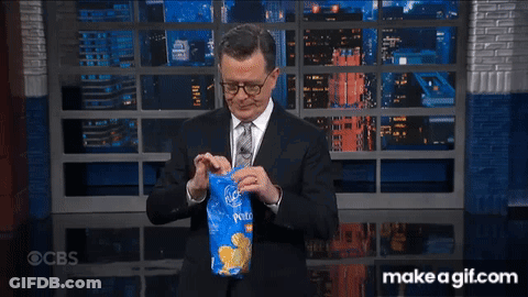 Man In Suit And Tie At Window With City Skyline GIF