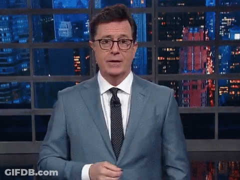 Man In Suit And Tie At Window With City View GIF