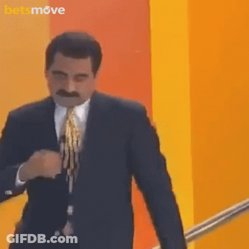 Man In Suit And Tie At Yellow Wall With Betsmove Logo GIF