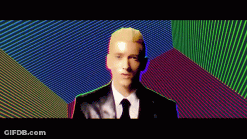 Man In Suit And Tie Before Colorful Wall GIF
