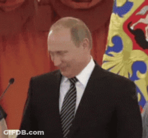 Man In Suit And Tie Before Flag GIF
