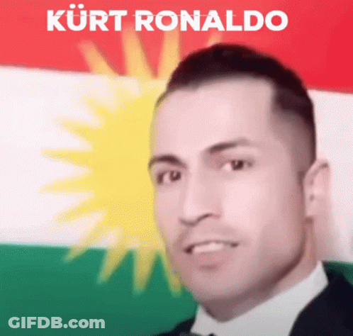 Man In Suit And Tie Before Kurdish Flag Kurt Ronaldo GIF