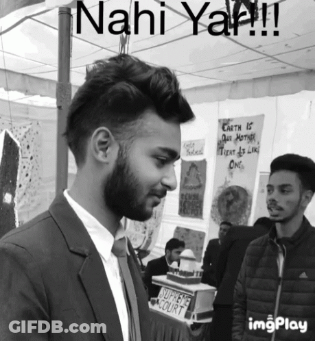 Man In Suit And Tie Before Sahi Court Sign GIF