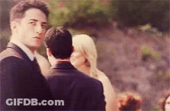 Man In Suit And Tie Before Woman In White GIF