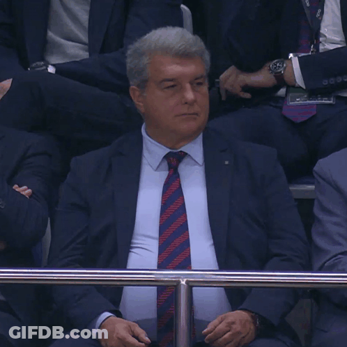 Man In Suit And Tie Behind Fence GIF
