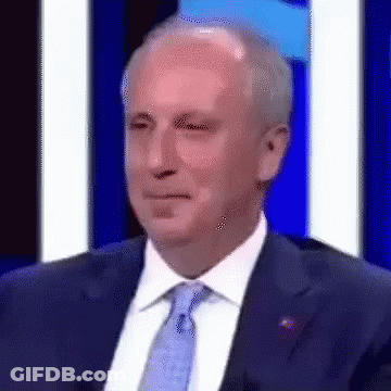 Man In Suit And Tie Beside Blue Wall GIF