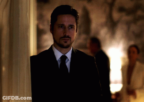 Man In Suit And Tie Beside Wall GIF