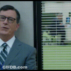 Man In Suit And Tie Beside Window With Blinds GIF