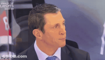 Man In Suit And Tie By Stanley Cup Layoffs Banner GIF
