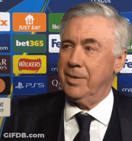 Man In Suit And Tie By Wall With Walkers And Bet365 Logos GIF