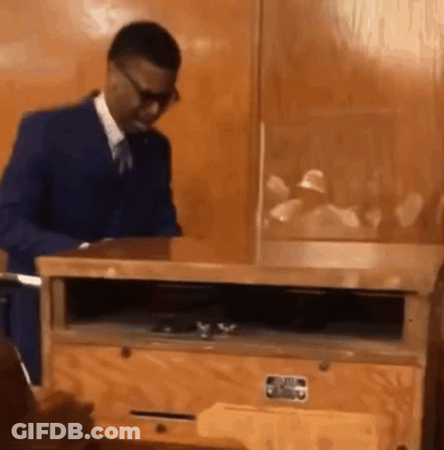 Man In Suit And Tie By Wooden Box GIF