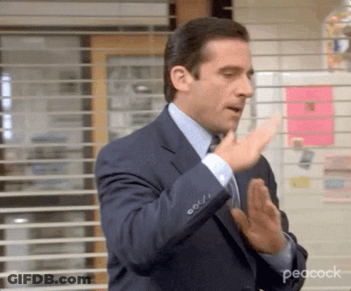 Man In Suit And Tie Clapping Hands In Front Of Window With Blinds GIF