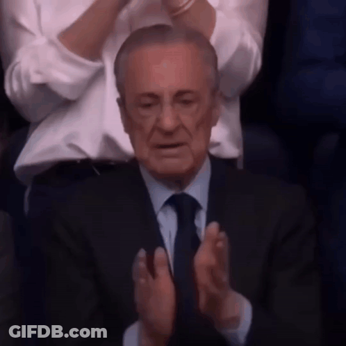 Man In Suit And Tie Clapping In Crowd GIF