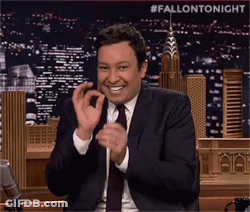 Man In Suit And Tie Clapping With City Skyline GIF