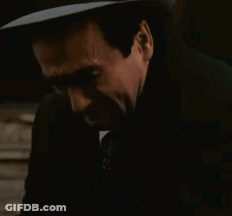 Man In Suit And Tie Covering Ears GIF