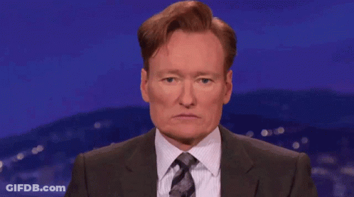 Man In Suit And Tie Covering Eyes GIF