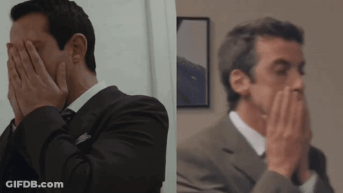 Man In Suit And Tie Covering Face GIF