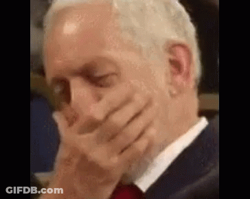 Man In Suit And Tie Covering Mouth GIF
