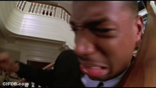 Man In Suit And Tie Crying By Stairs GIF
