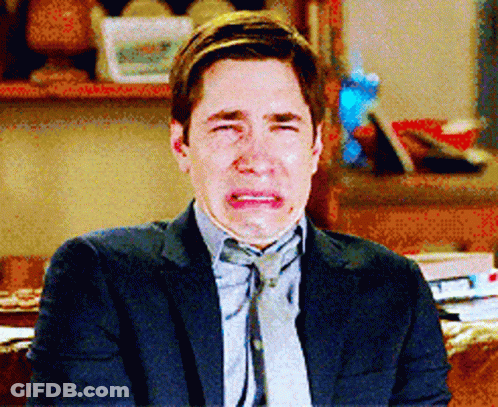 Man In Suit And Tie Crying On Couch GIF