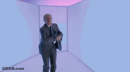 Man In Suit And Tie Dancing In Cube GIF