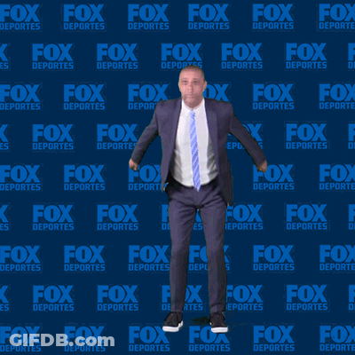 Man In Suit And Tie Dancing In Front Of Fox Deportes Background GIF