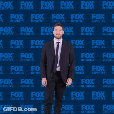 Man In Suit And Tie Dancing In Front Of Fox Deportes Background GIF
