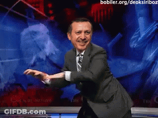 Man In Suit And Tie Dancing In Front Of Screen Saying Bobller.org/deoksiriboz GIF