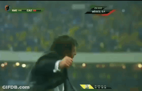 Man In Suit And Tie Dancing In Front Of Screen Saying Mexico GIF