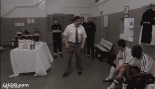 Man In Suit And Tie Dancing In Locker Room GIF