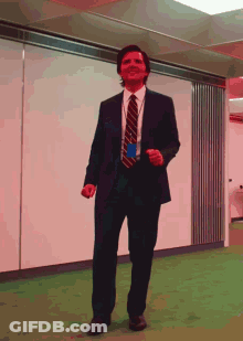 Man In Suit And Tie Dancing In Office GIF