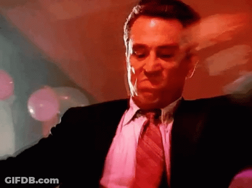 Man In Suit And Tie Dancing In Red Room GIF