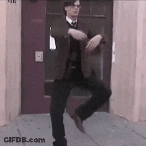 Man In Suit And Tie Dancing On One Leg GIF