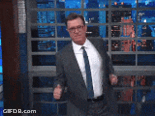 Man In Suit And Tie Dancing On Stage GIF