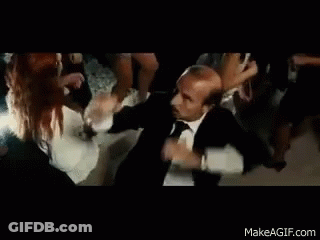 Man In Suit And Tie Dancing With Group GIF