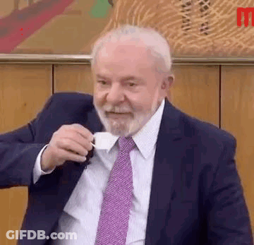Man In Suit And Tie Drinking Coffee GIF
