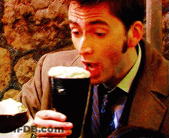 Man In Suit And Tie Drinking From Glass GIF