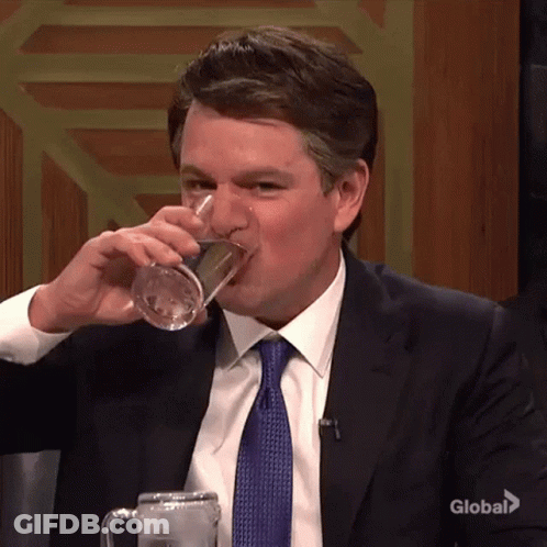 Man In Suit And Tie Drinking Water From Mug GIF