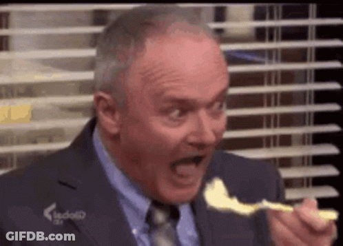 Man In Suit And Tie Eating Cheese With Spoon GIF