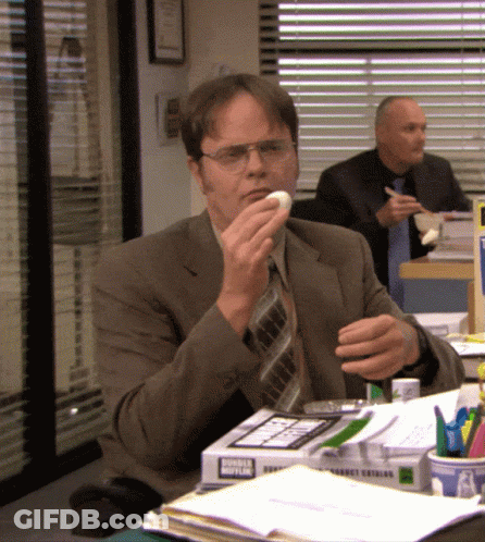 Man In Suit And Tie Eating Donut From Donut King Box GIF